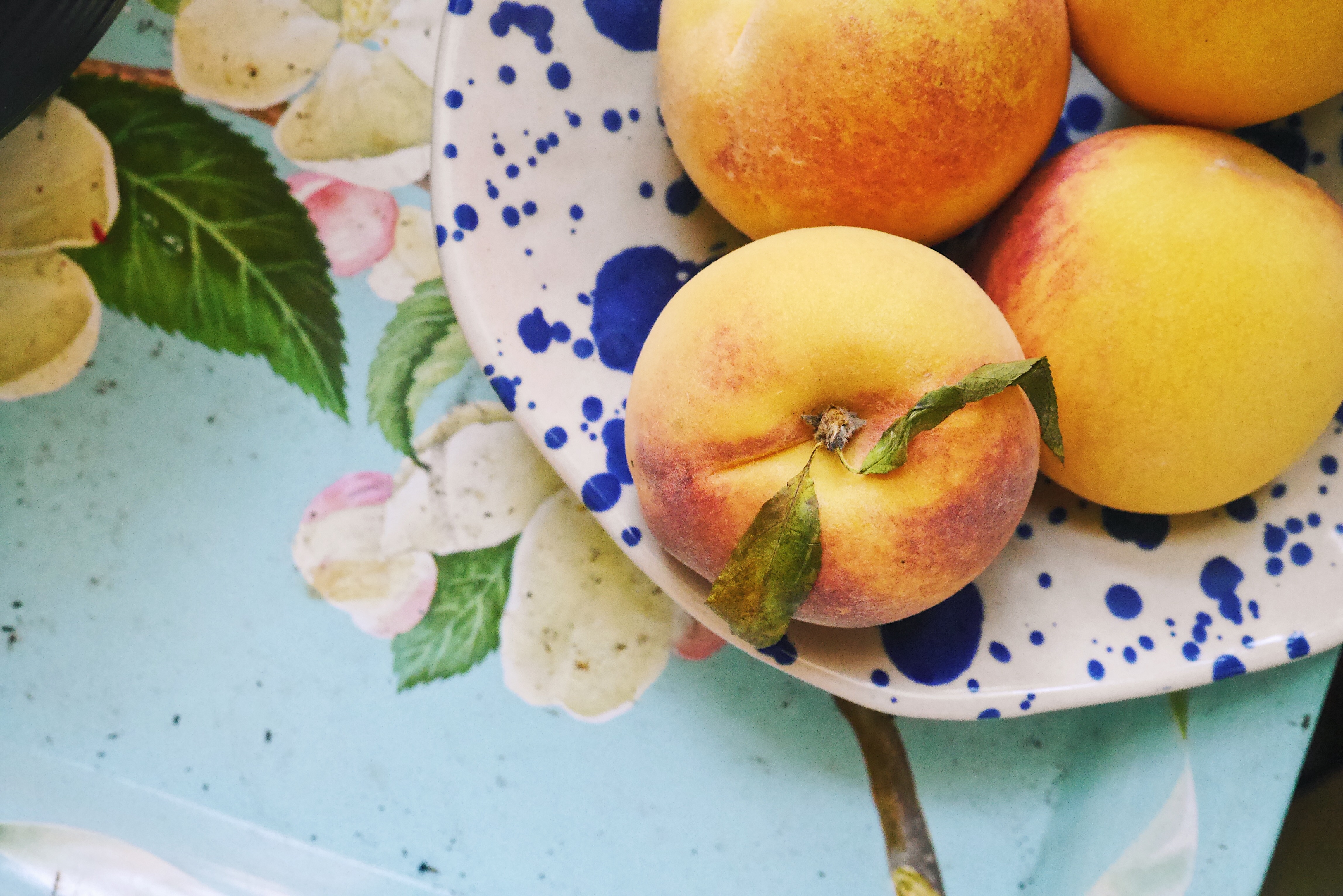 Ripe summer peach in a bowl