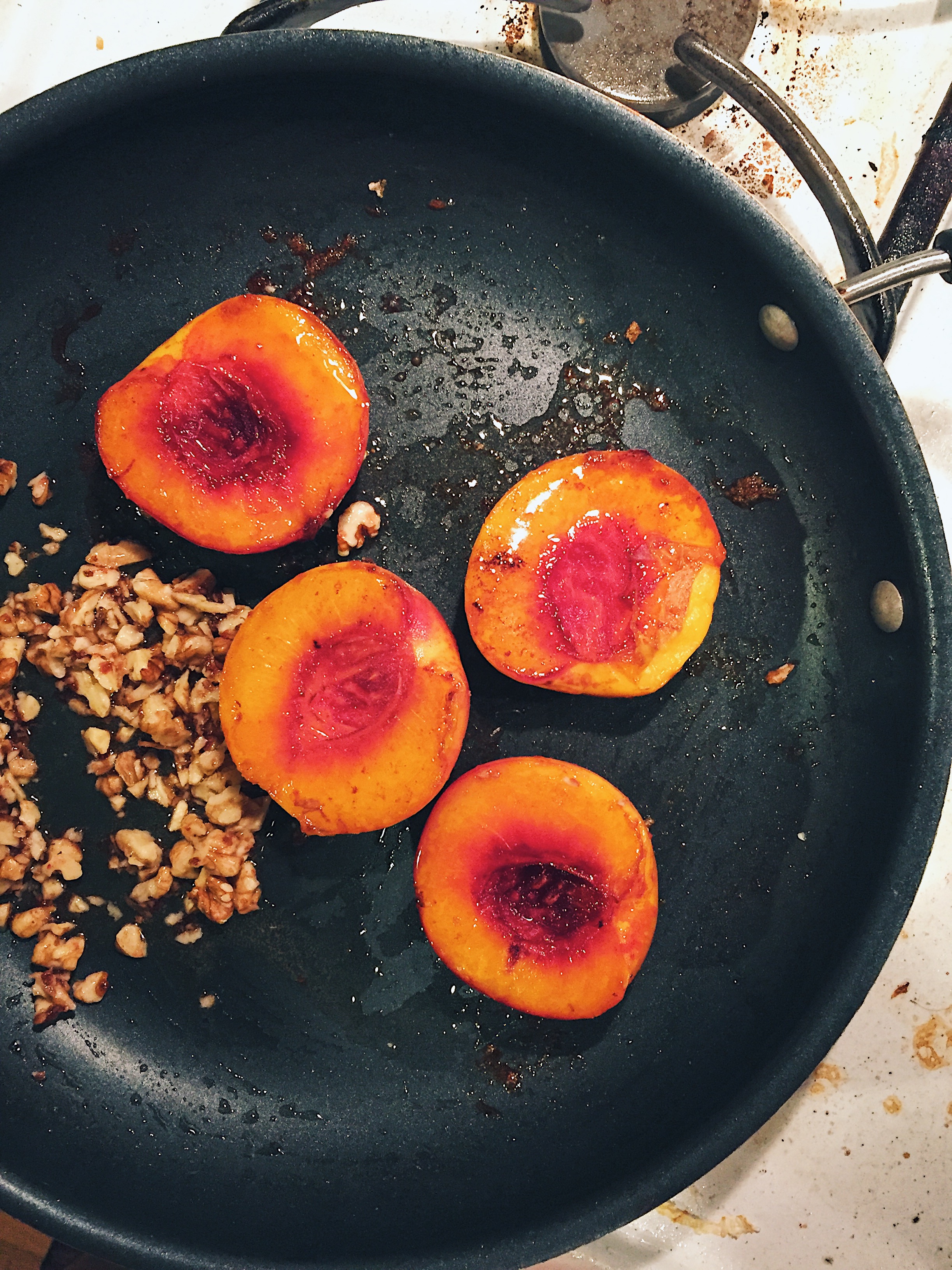 butter poached peaches topped with walnuts